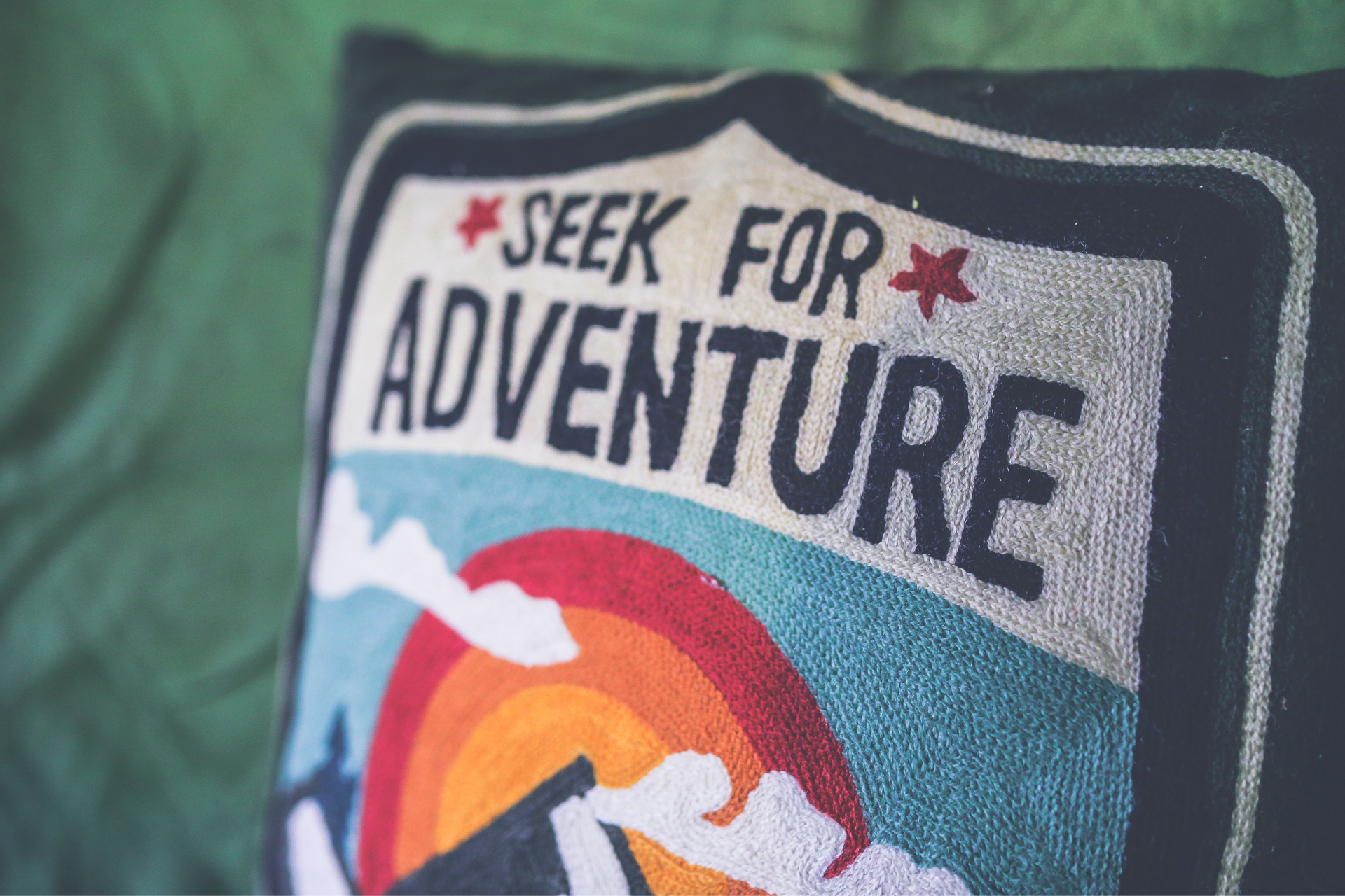 pillow that says to seek for adventure