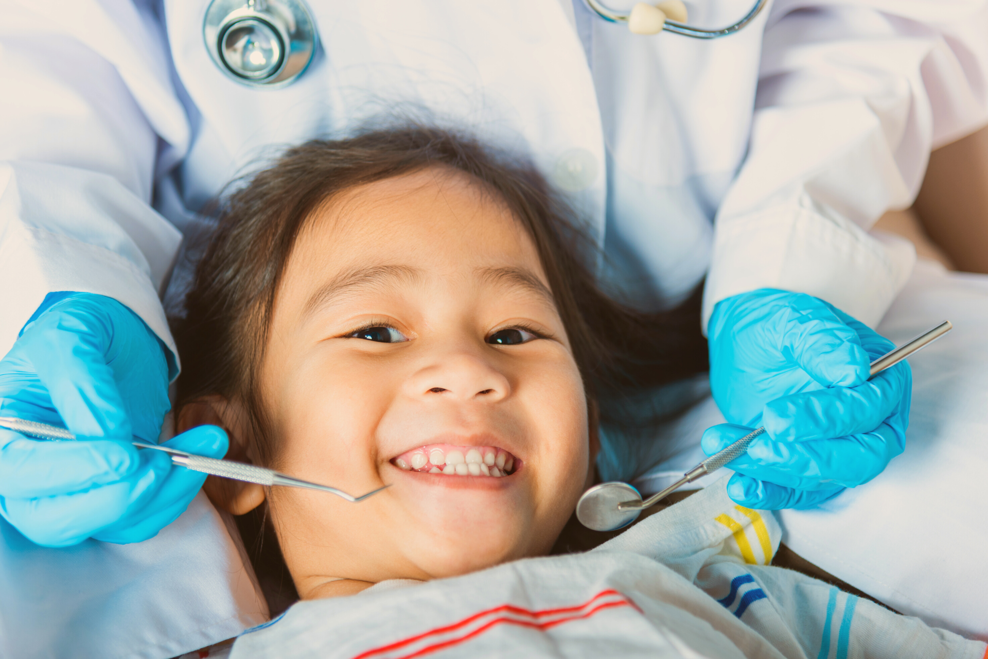 girl at her first dentist visit learning what is good for teeth